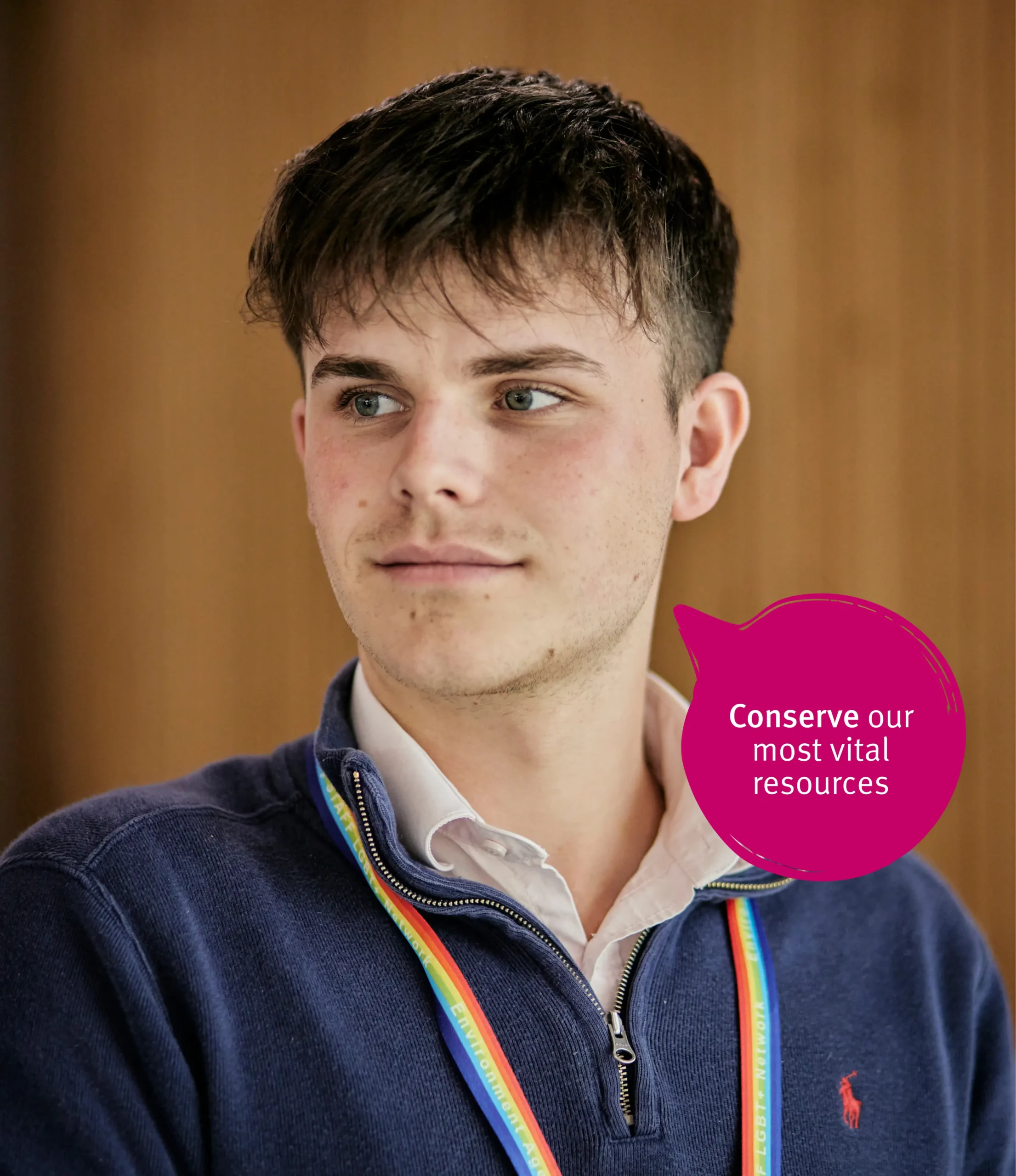 Boy in blue shirt smiling and looking towards left